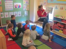 The preschoolers listing to book on animal sounds